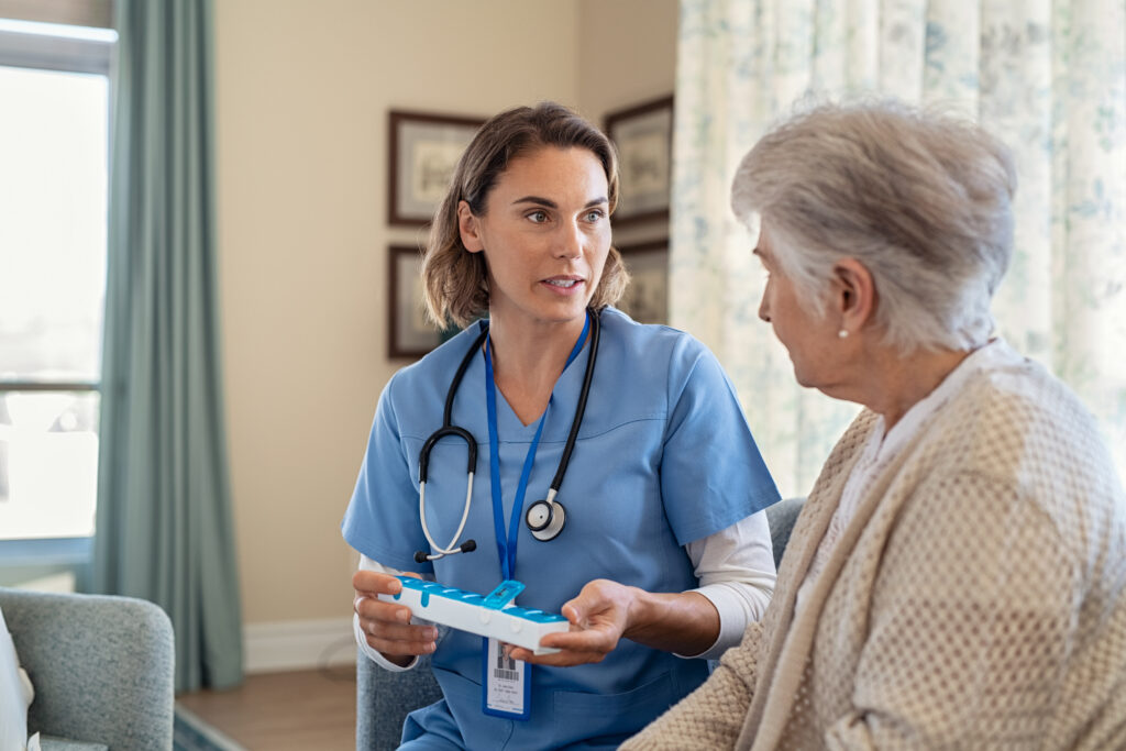 nurse explaining medicine dosage to senior woman at nursing home